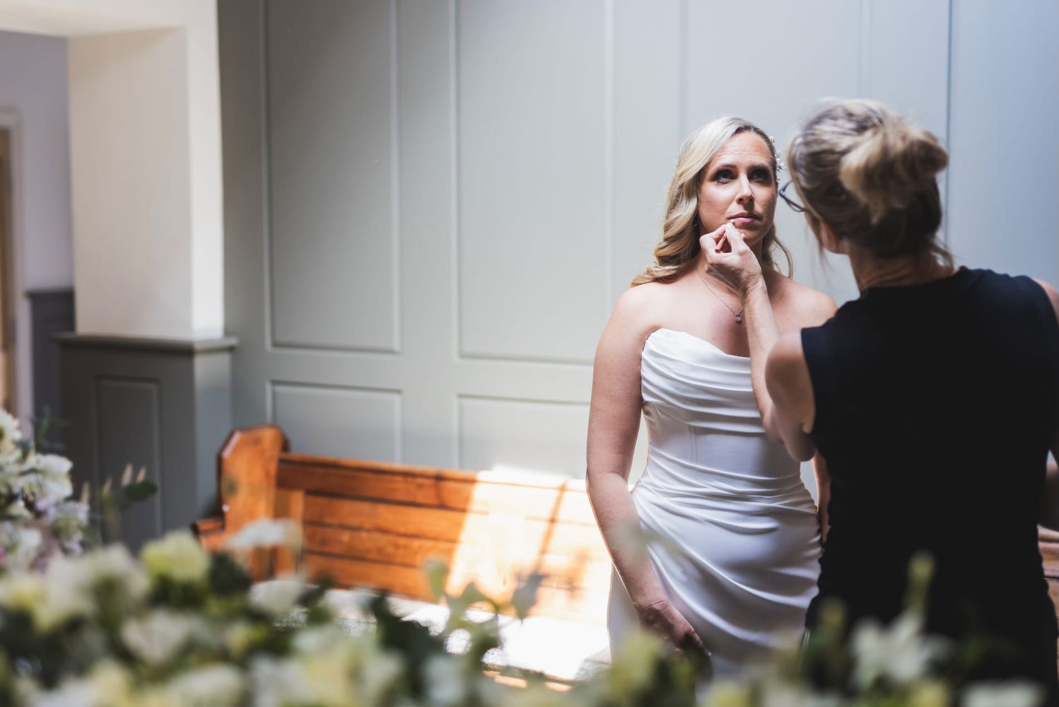 Leanne applying makeup to bride